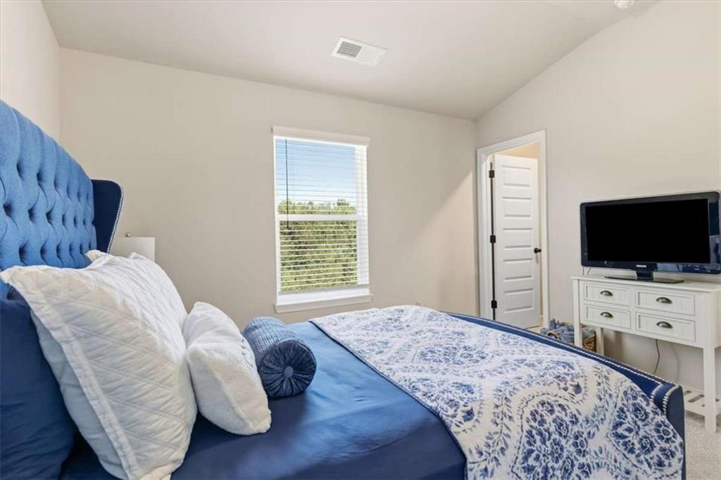 1171 Bodega Loop Locust Grove, GA 30248 - Photo 40 of 57 a bedroom with a bed and a flat screen tv