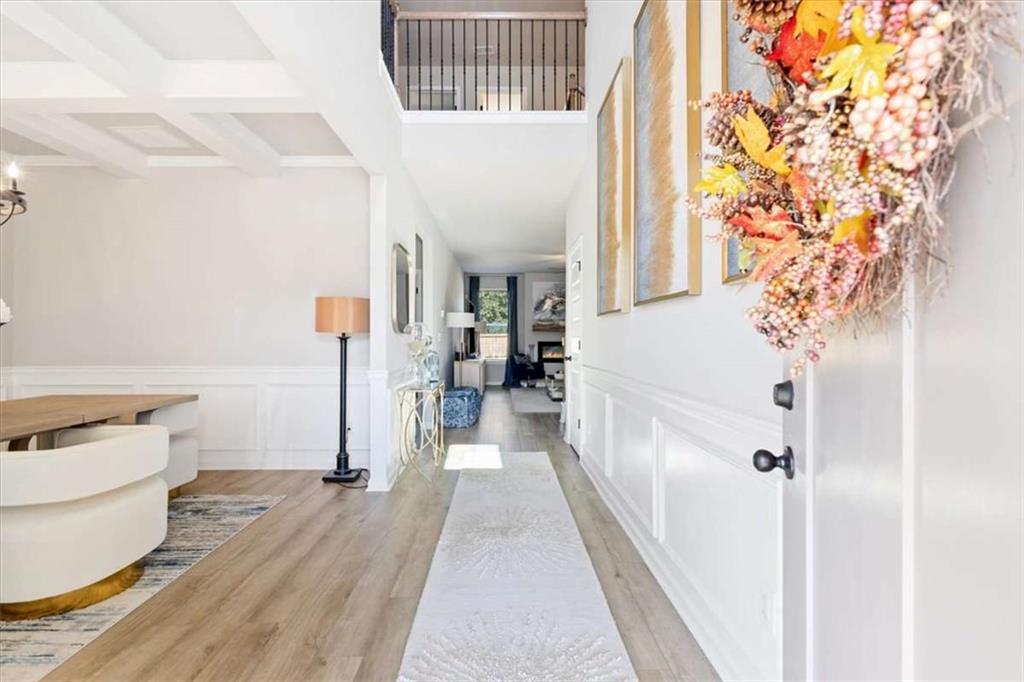 1171 Bodega Loop Locust Grove, GA 30248 - Photo 5 of 57 a view of a hallway with wooden floor and staircase