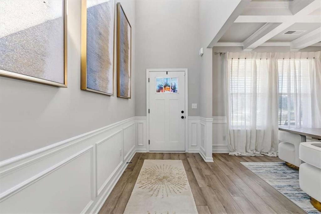 1171 Bodega Loop Locust Grove, GA 30248 - Photo 6 of 57 a view of a hallway with wooden floor and staircase