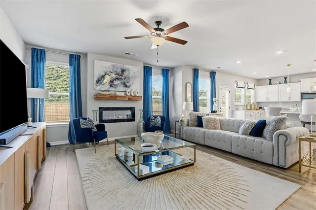 a living room with furniture and a chandelier