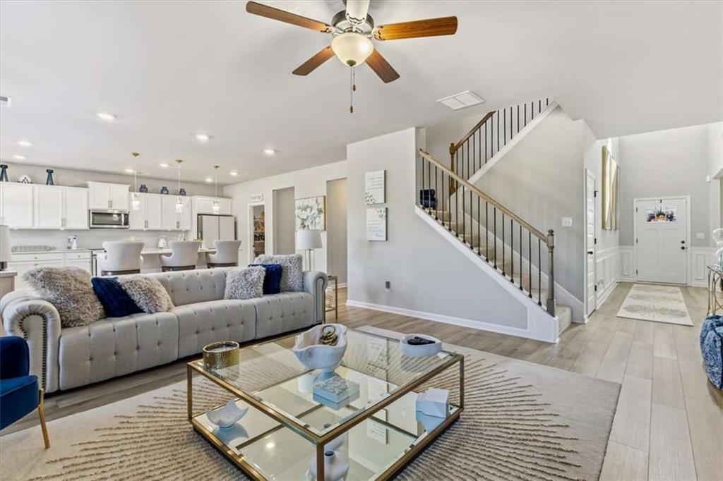1171 Bodega Loop Locust Grove, GA 30248 - Photo 10 of 57 a living room with furniture and a chandelier
