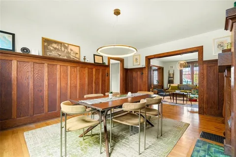 a view of a dining room with furniture and chandelier