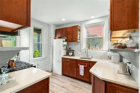 a kitchen with stainless steel appliances a sink stove and window