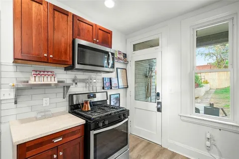 a kitchen with stainless steel appliances granite countertop a stove and a microwave