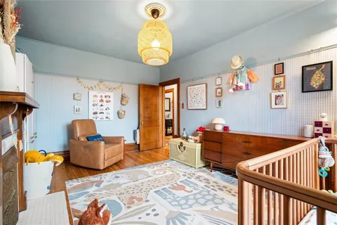 a bedroom with furniture and wooden floor