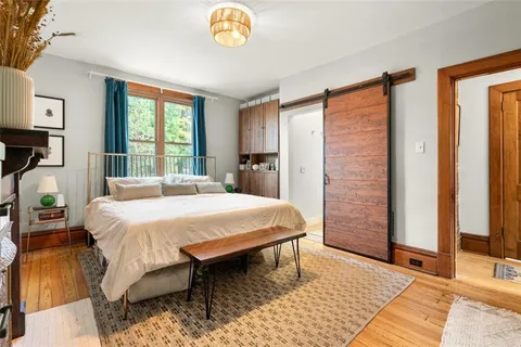 a spacious bedroom with a bed and a window