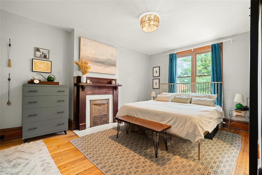 303 Kearsarge Street Pittsburgh, PA 15211 - Photo 26 of 50 a bedroom with a bed and a dresser next to a window