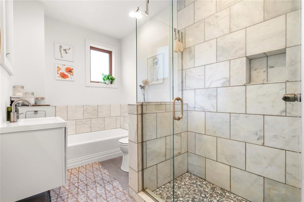 303 Kearsarge Street Pittsburgh, PA 15211 - Photo 27 of 50 a bathroom with a sink a toilet and shower