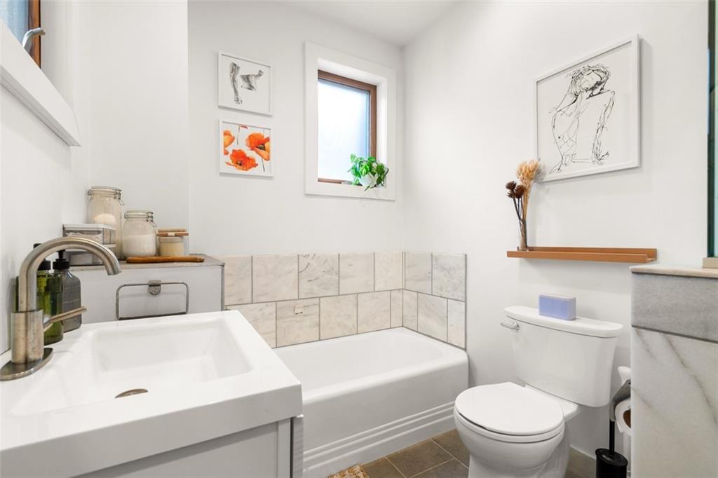 303 Kearsarge Street Pittsburgh, PA 15211 - Photo 28 of 50 a bathroom with a sink a toilet and shower