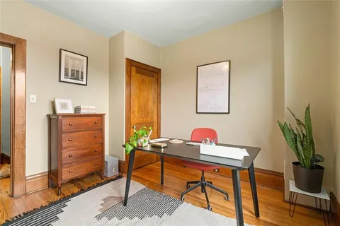 a work room with furniture and wooden floor