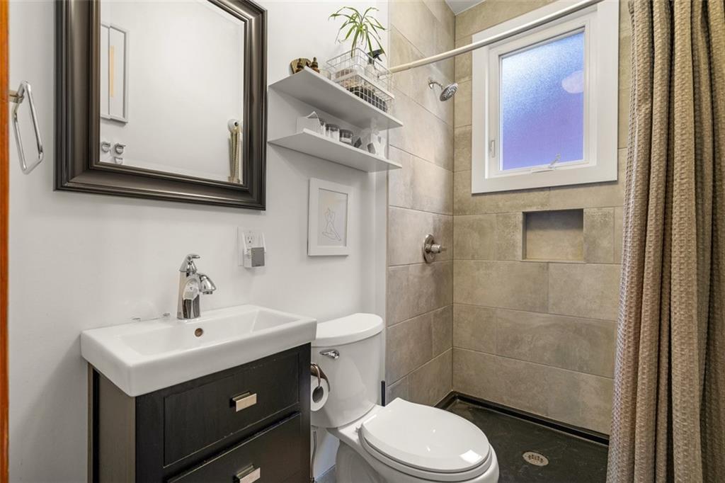 303 Kearsarge Street Pittsburgh, PA 15211 - Photo 31 of 50 a bathroom with a sink vanity mirror and toilet
