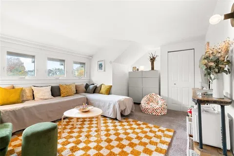 a bedroom with furniture and wooden floor
