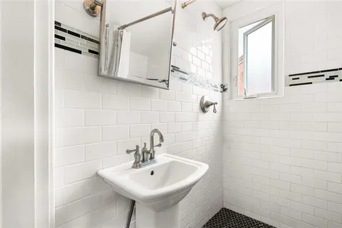 a bathroom with a sink a mirror and shower