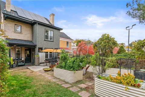 a front view of a house with swimming pool fire pit and outdoor seating