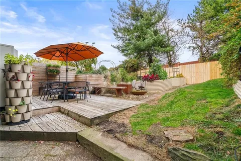 a view of a backyard with sitting area