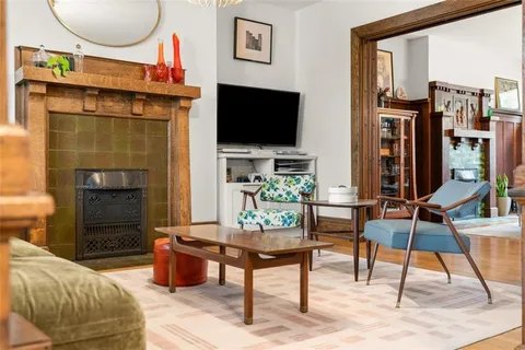 a living room with furniture a flat screen tv and a fireplace