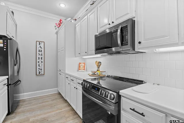 a kitchen with stainless steel appliances granite countertop a sink stove and microwave