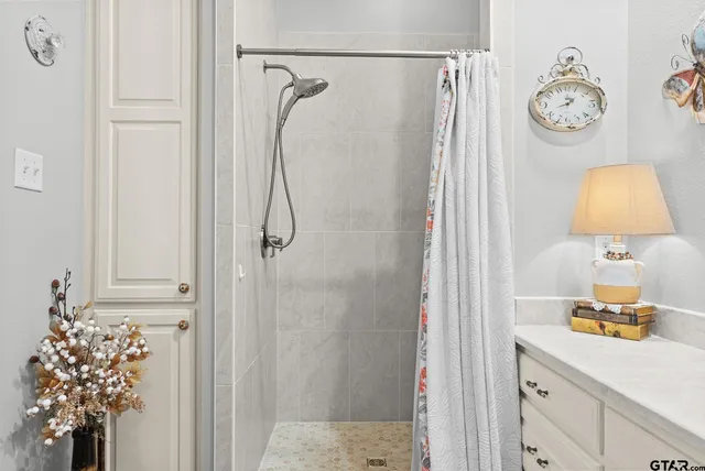 a bathroom with a shower and a mirror