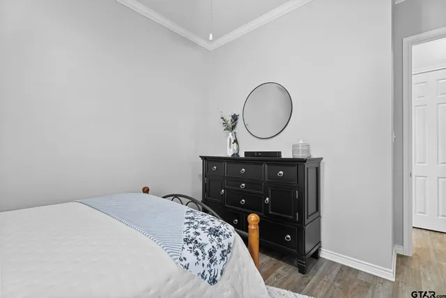 a bedroom with a bed and a mirror