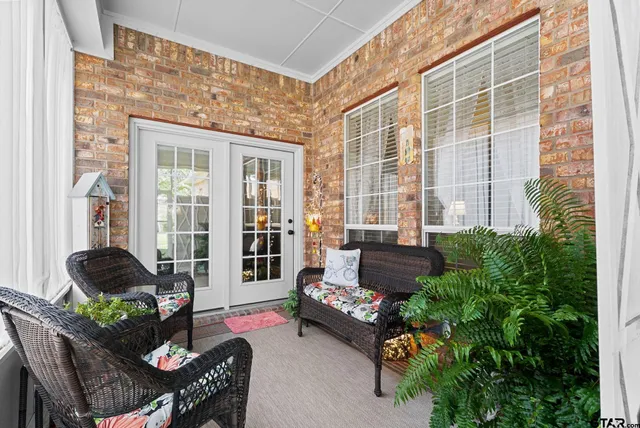 a living room filled with furniture and a potted plant