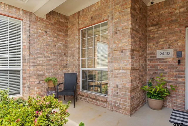 a brick building with a potted plant on the side