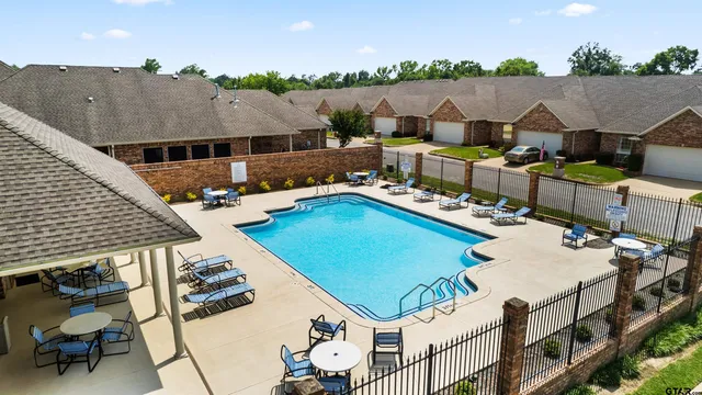 an aerial view of a house with pool and furniture