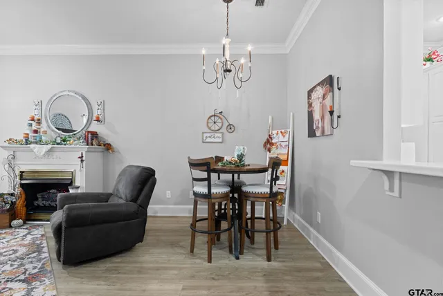 a view of a dining room with furniture wooden floor and a chandelier