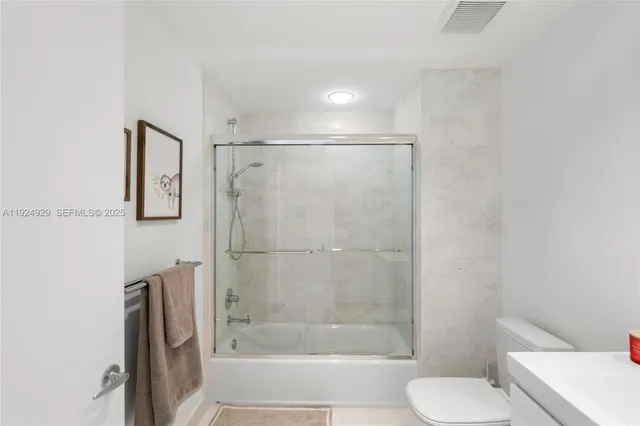 a dining room with furniture a chandelier and wooden floor