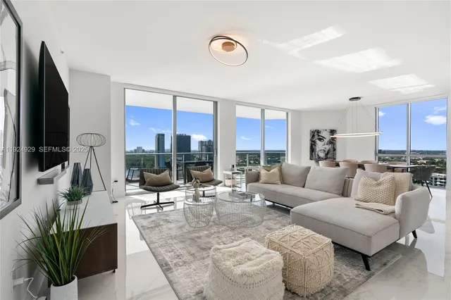 a large white kitchen with a sink stainless steel appliances and cabinets