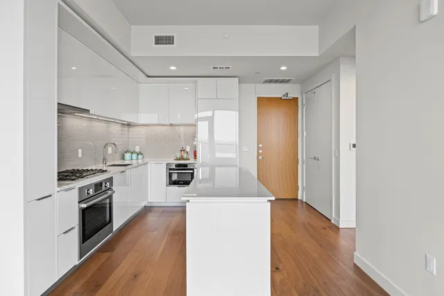 a large kitchen with a stove top oven