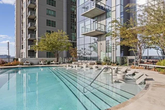 a view of a patio with swimming pool table and chairs