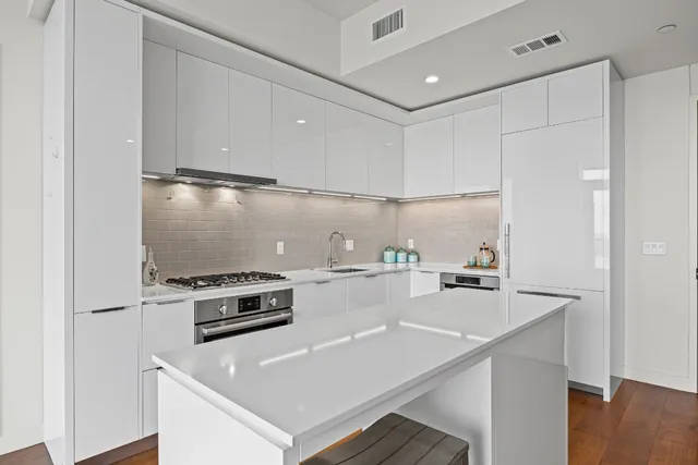 a kitchen with a stove a sink and a refrigerator