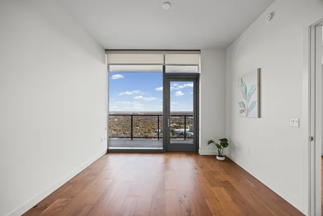 wooden floor in an empty room with a window
