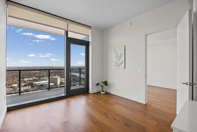 wooden floor in an empty room with a window