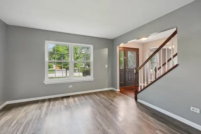a view of an entryway with wooden floor and windows
