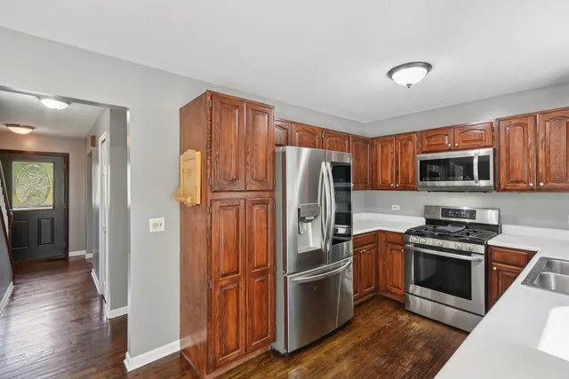 a kitchen with stainless steel appliances granite countertop a refrigerator stove and microwave