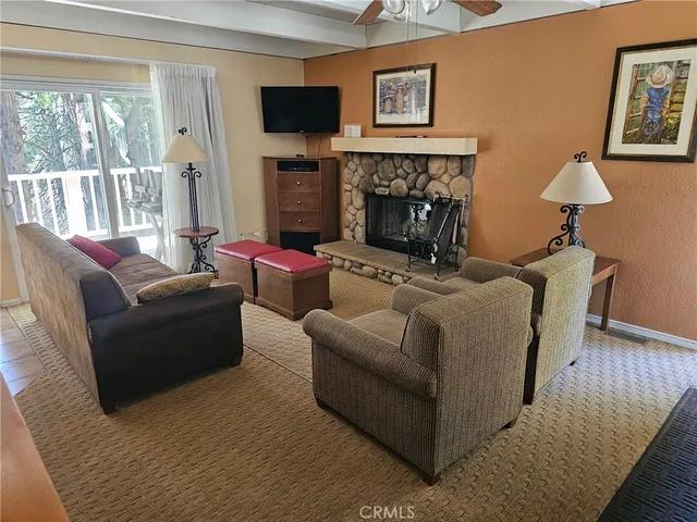 a living room with furniture flat screen tv and a fireplace