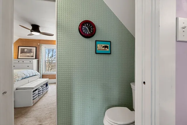 a bathroom with a toilet and a shower curtain