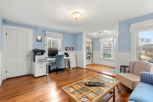 a living room with furniture and wooden floor