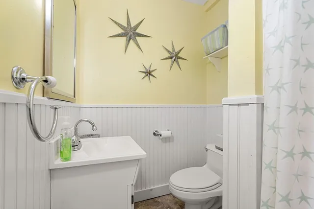 a bathroom with a sink a toilet and a mirror