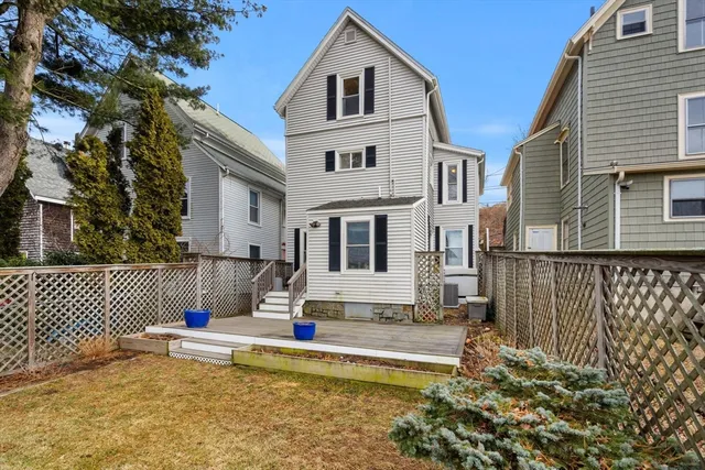 a view of a house with a swimming pool and a yard