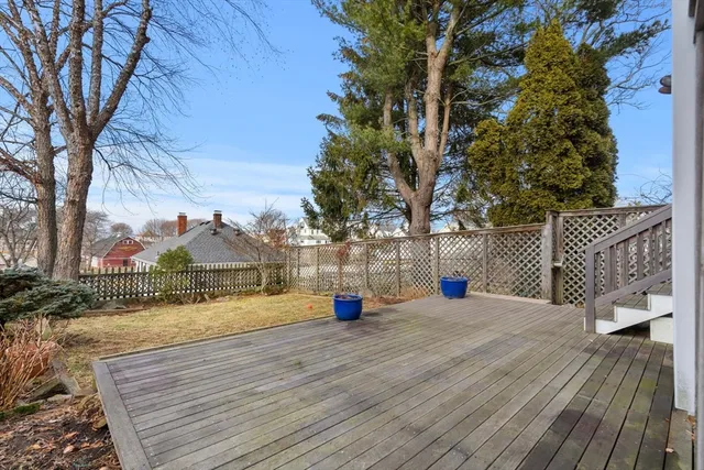 a park view with large trees and wooden fence
