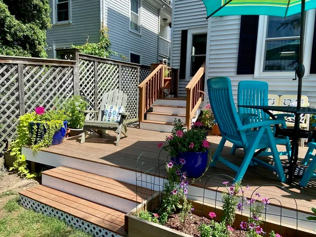 a view of a chairs and table in a backyard