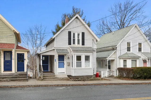 a front view of a house with a road