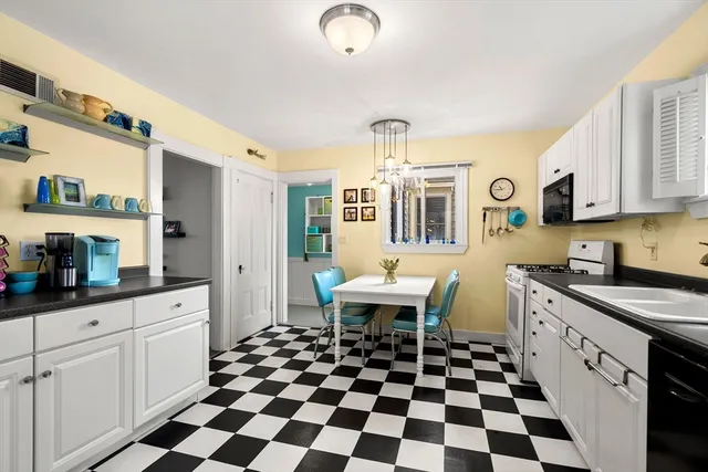 a kitchen with a sink a stove and cabinets