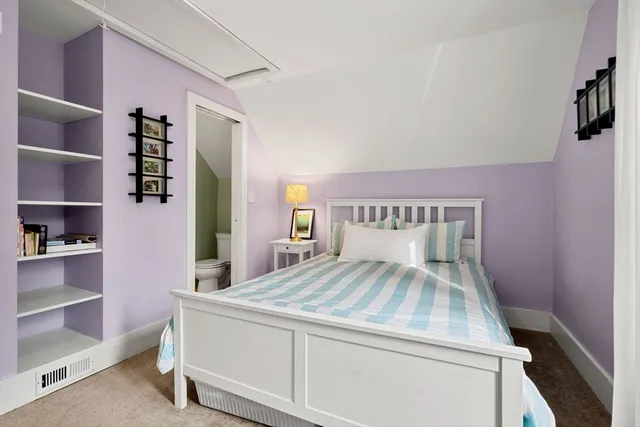 a bedroom with a bed and a book shelf