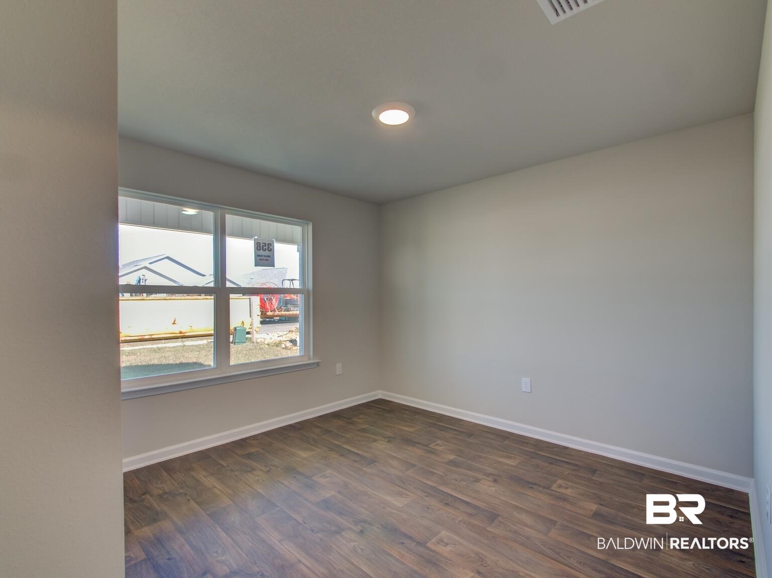23953 Citation Loop Daphne, AL 36526 - Photo 29 of 49 Spare room with baseboards and dark wood finished floors