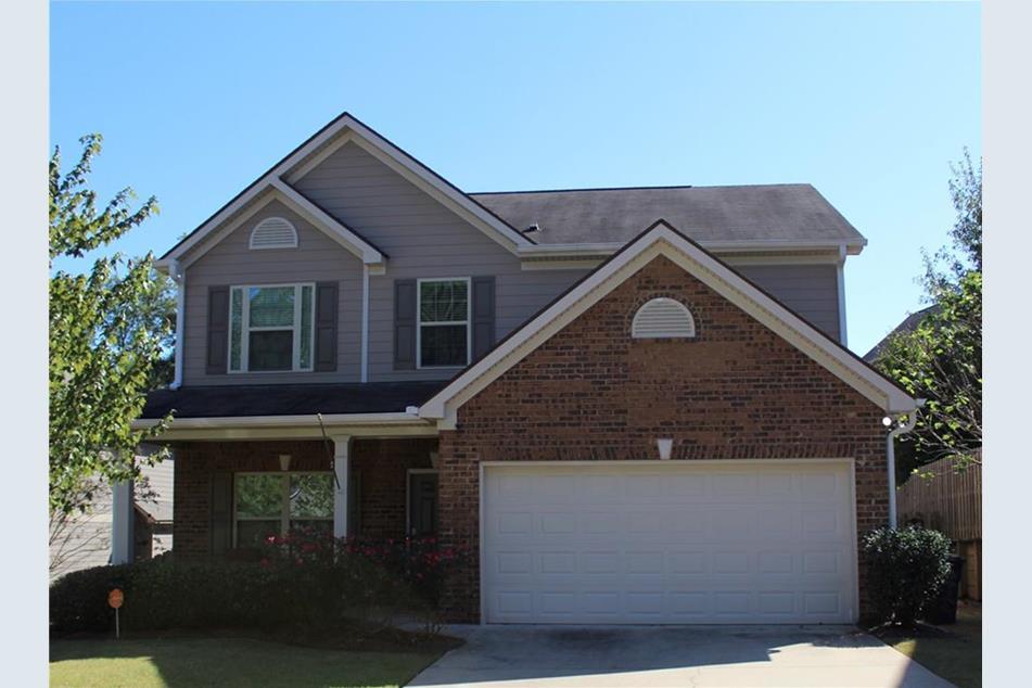 a front view of a house with yard