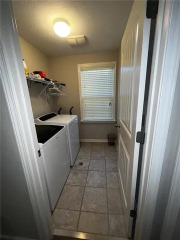 a spacious bedroom with a bed and a chandelier