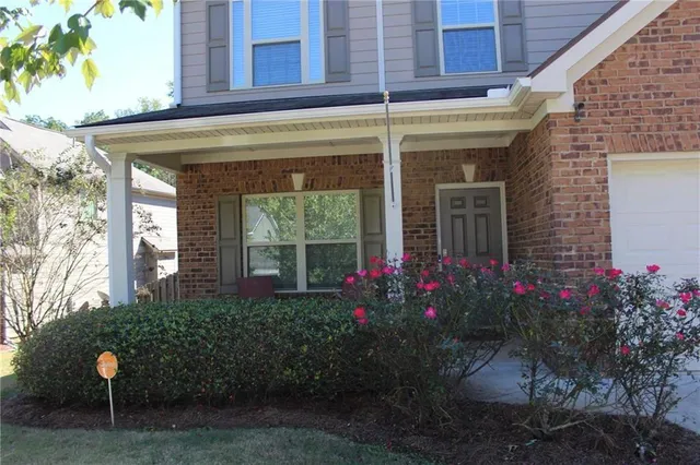 a view of a house with potted plants